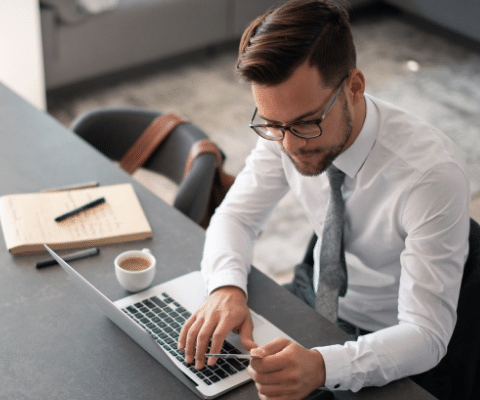 Businessman using laptop and holding a credit card