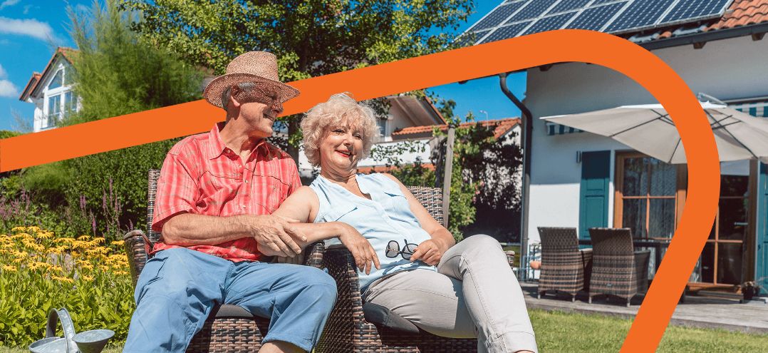 mature couple sitting in the sun smiling