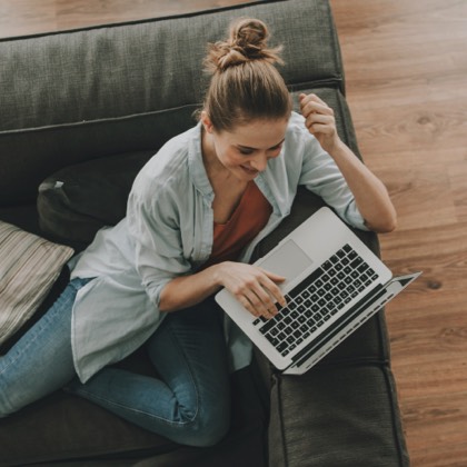 A top-down view of a woman using a laptop.