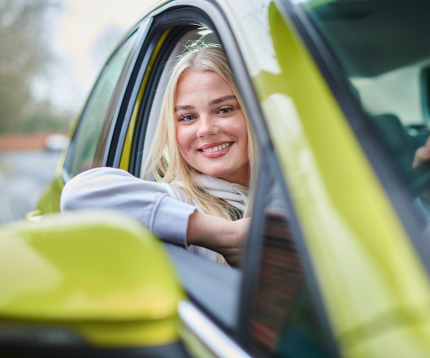Woman smiling in a car.