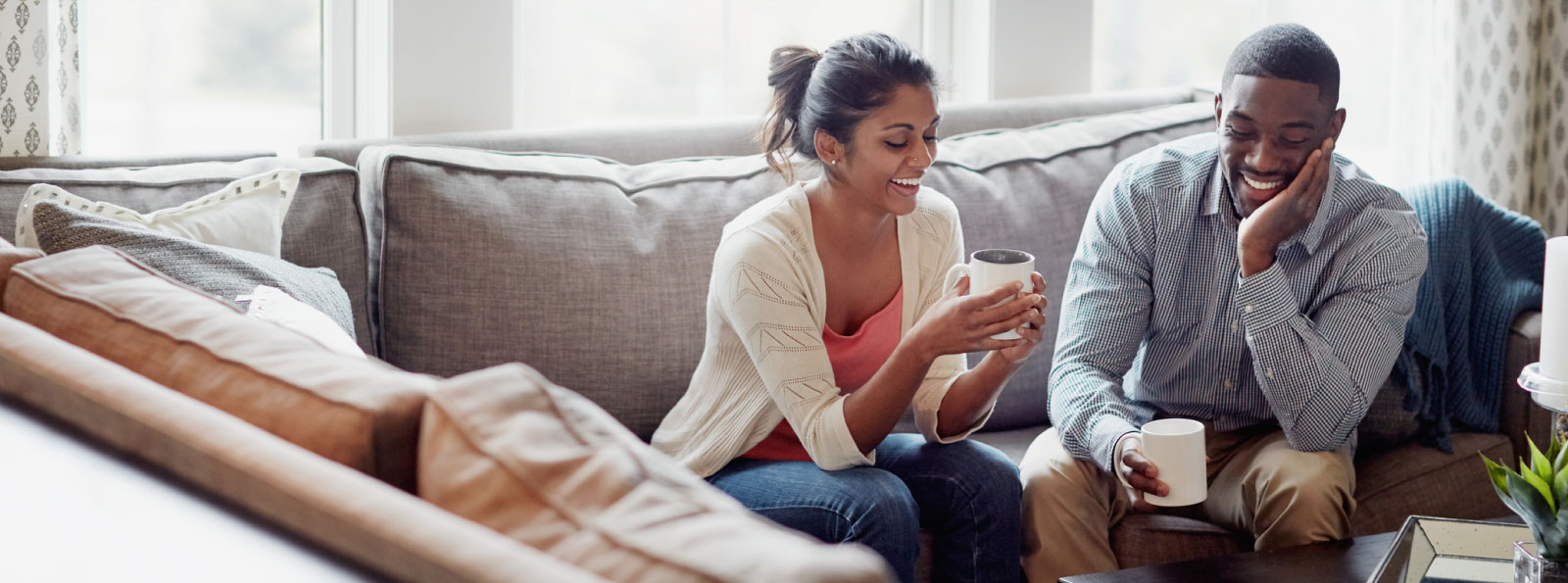 a couple sitting on their living room couch