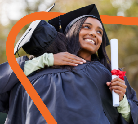 Smiling Female wearing a cap and gown and hugging another person.