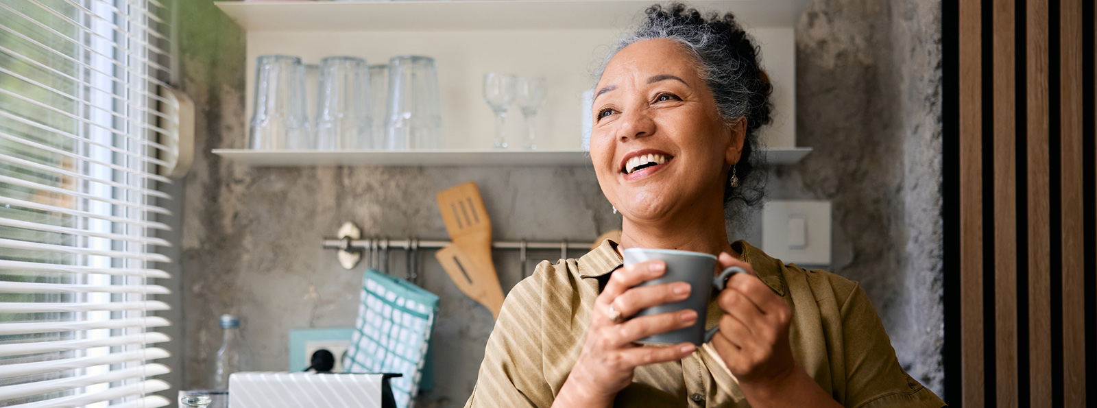 Woman holding a cup and smiling