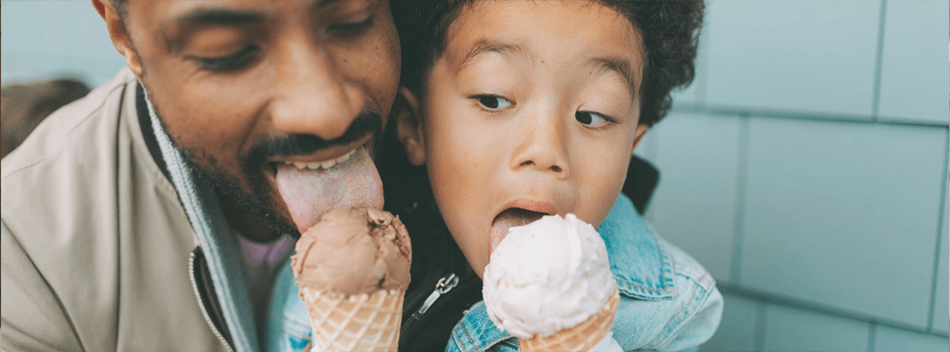 Father and daughter eating ice cream cones