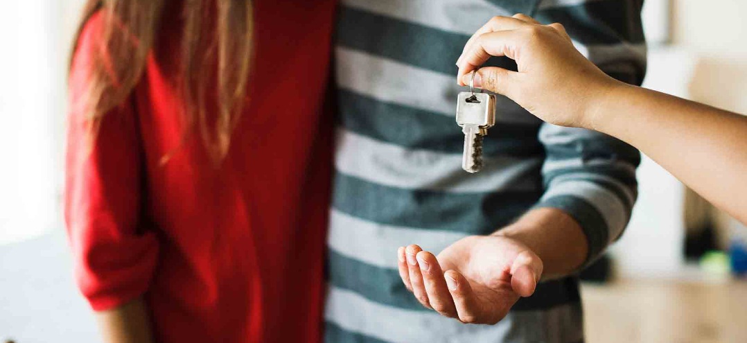 a couple getting keys to their new home