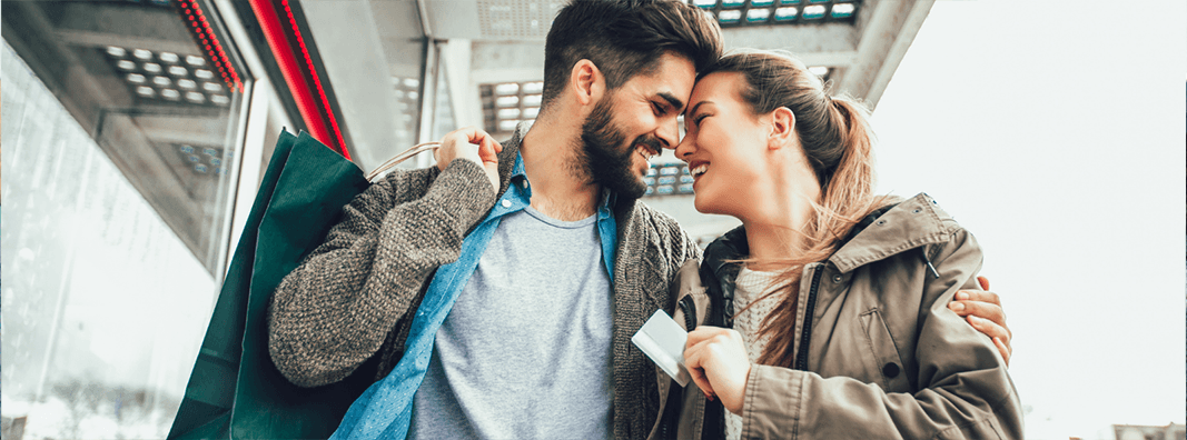 Couple shopping and holding a credit card.