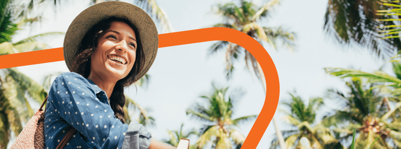 Smiling woman on a bike with palm trees in the background.