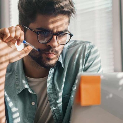 a man concentrating while looking at his computer