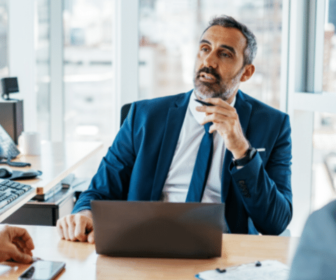 Businessman sitting in front of a laptop