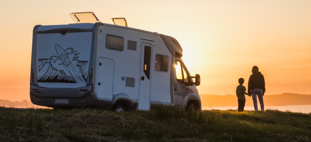 an RV parked overlooking a sunset