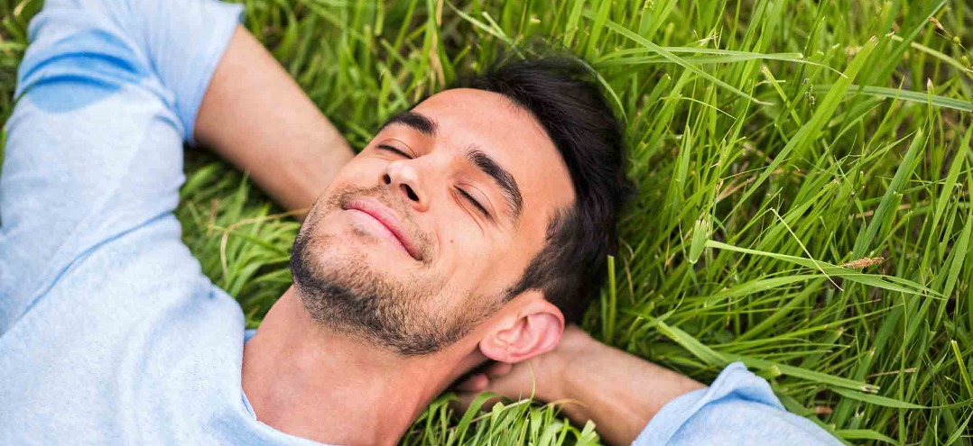 a man laying on grass