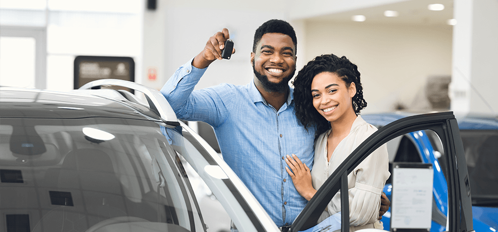 Costco Car Buying photo of couple standing by car with key in hand